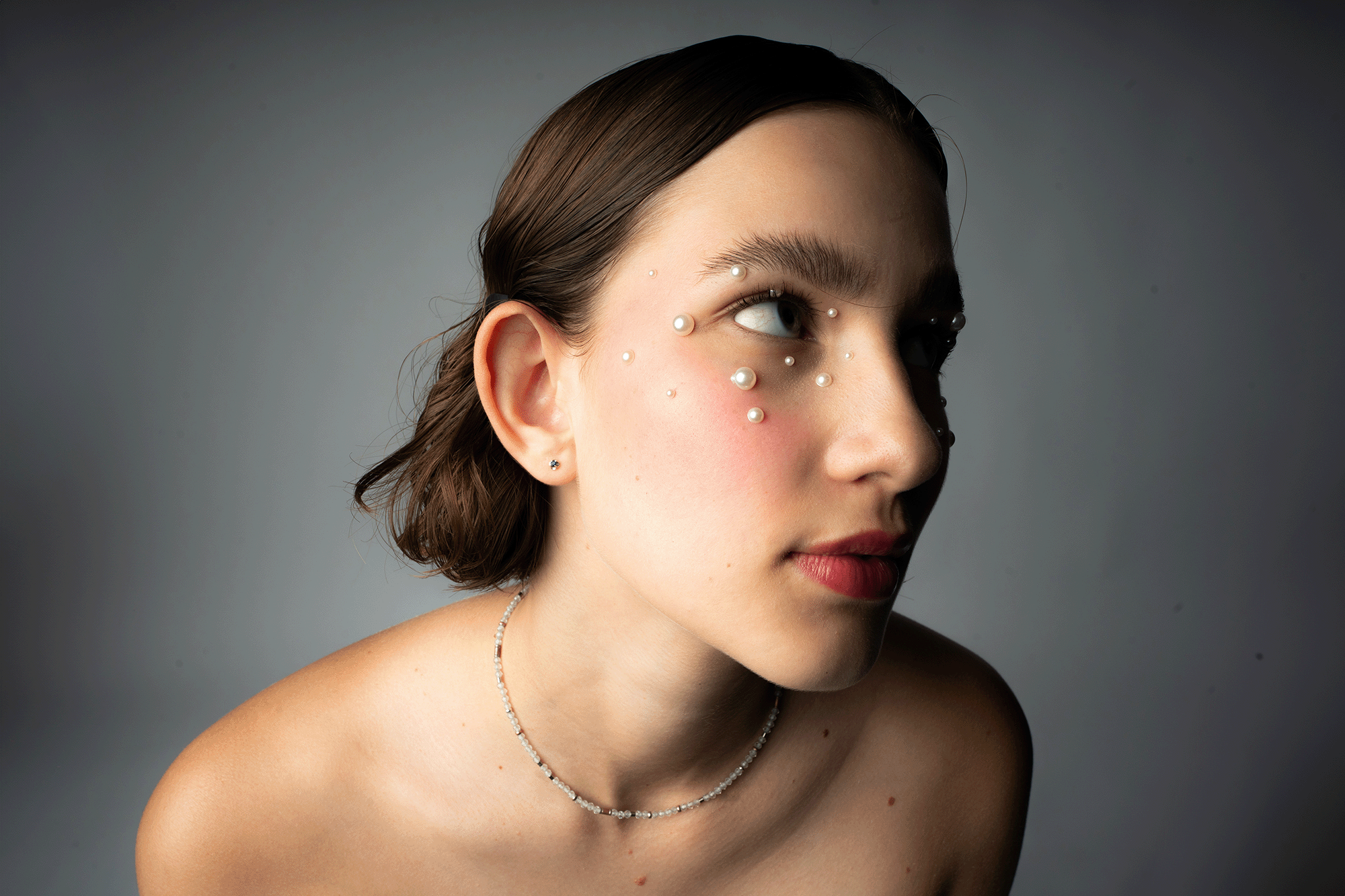 Beauty-Portrait mit Perlen-Make-up im Seitenlicht